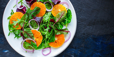 healthy salad tangerines citrus, lettuce, arugula and other herbs. Menu concept food background, keto or paleo diet. top view. copy space for text