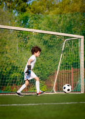 Summer soccer tournament for young kids. football club. emotions and joy of the game. Young goalie. Kids - soccer champion. Boy goalkeeper in football sportswear on stadium with ball. Sport concept.