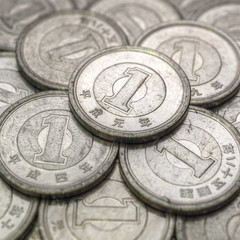 Field of Japanese coins at 1 yen close-up. Illustration with aged effect. News about the economy, finance and central bank of Japan. External and public debt, deflation. Square shot. Macro