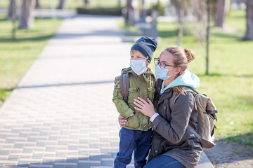 Mother and her son outdoor wearing masks