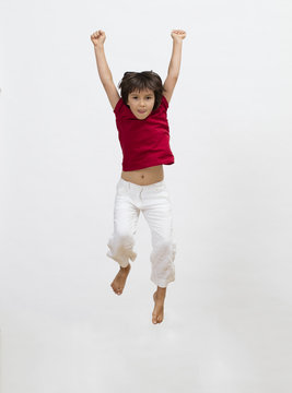 isolated beautiful child jumping high to express freedom and happiness