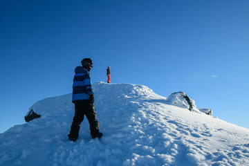 Travellers hiking to the top of snow mountain in south island, New Zealand.