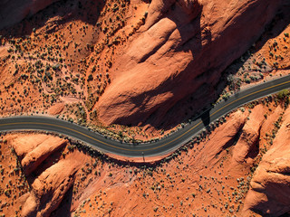 Aerial view of winding road passing through desert landscape