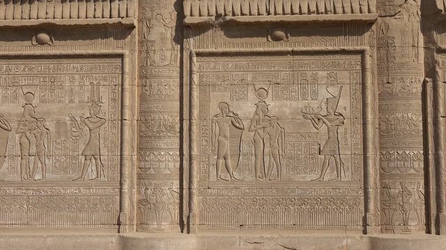 Hieroglyphic carvings on the exterior walls of an ancient egyptian temple, 4k