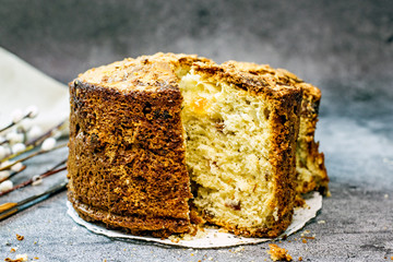 Panettone delicious christmas italian traditional cupcake closeup. Sliced cupcake with pieces of dried fruit on a dark background, copy space