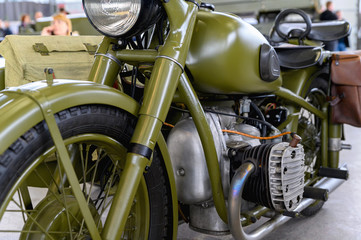 Fragment of an old military motorcycle. A khaki military motorcycle.
