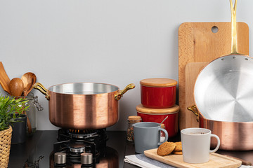 Metal pot on a gas stove burner at home kitchen close up
