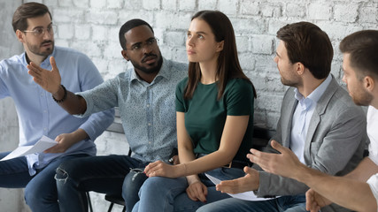 Angry diverse multiethnic applicants argue with confident female before recruitment talk, mad multiracial male candidates discriminate woman intern before interview, gender discrimination concept