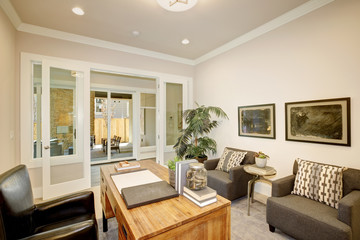 Fototapeta na wymiar Light home office features a wooden desk. Luxury American modern home.