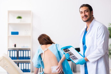 Injured young woman visiting young male doctor
