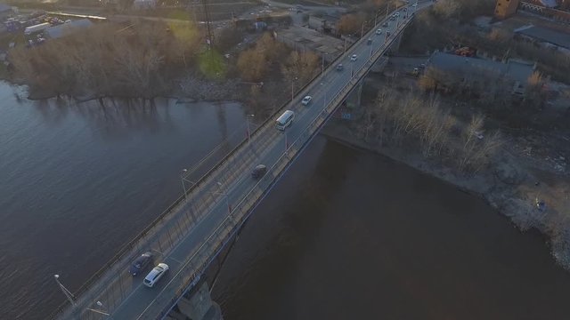 Flight over the busy traffic of cars on a bridge over water. bridge on the river or sea coast. River and bridge aerial view. High above the water. flying drone with a camera. Urban city landscape. 