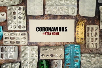 Used blister packs of pills on rusty background with a message. Coronavirus, Stay Home concept.