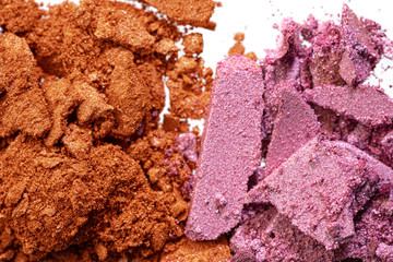 Make up background of mixed colored smashed eyeshadows close up
