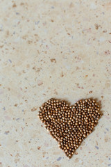 Brown pepper in the shape of a heart on table