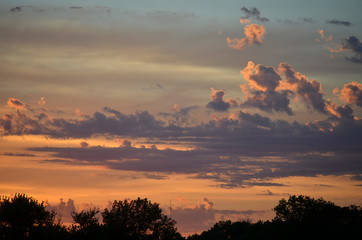 Fototapeta na wymiar Sunset Sky with Dramatic Dark Purple Clouds