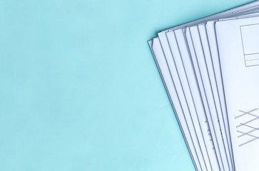 Stack Folding drawings on a blue background. Top view. Flat lay.