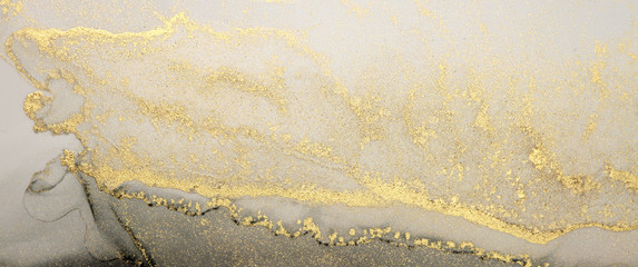 Abstract paint gold and black blots horizontal background. Alcohol ink colors. Marble texture.