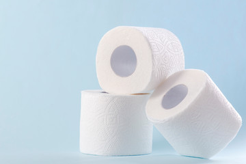 White toilet paper rolls on the gray background. Hygiene concept.