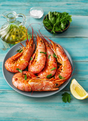 Close up of of a plate with big red prawns