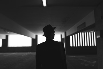 Rear view of man standing in parking lot