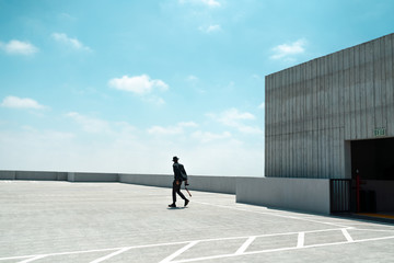 Man walking on rooftop of parking garage