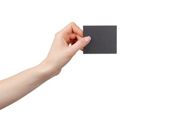 Fototapeta premium Female hand holding black businesscard isolated on white background, copy space