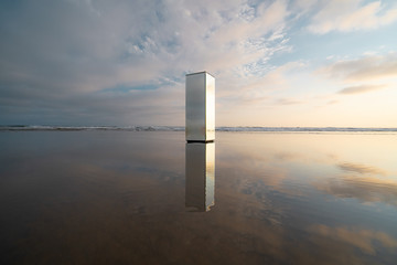 View of mirrored pillar on beach
