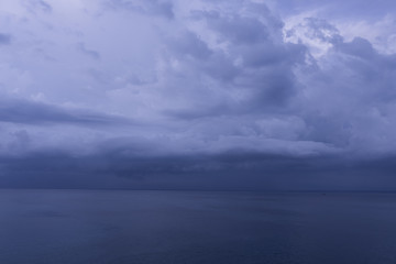 Beautiful blue sunset on the ocean with big waves and cliffs and cliffs. Bali island with its tropical and exotic nature. Sunrise over the sea and ocean. Phantom blue in sunset