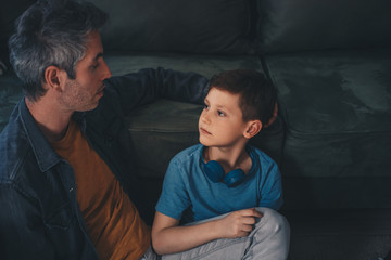 Dad and cute little son sharing an emotional hug.