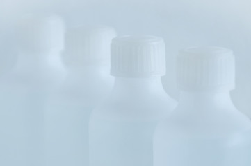 White plastic bottle with disinfectant. Selective focus white background.