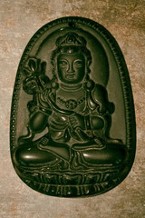 Old Buddhist amulet close-up.