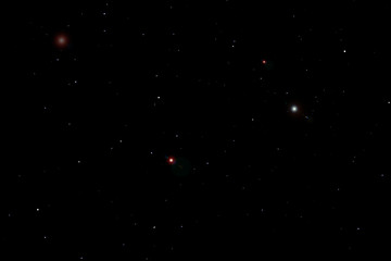 A starry black sky with many stars of various shades of red, white, and blue. The background can be used for drawing, images on fabric, marble tiles, or clothing. Space with space for the inscription.