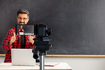 E-Learning . Adult man teacher is filming movie for online education.
