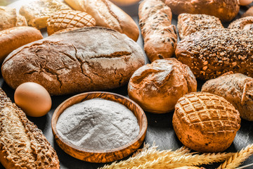 Fresh fragrant breads on the table. Bakery food concept panorama or wide banner photo.