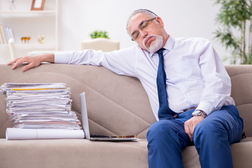 Aged businessman employee working from house