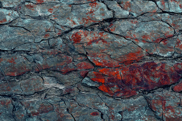 Natural basalt rock wall with cracks and crevices. Rock texture. Graphite stone wall. Stone background. Photography made with natural daylight. Texture for 3D models, designers, copy space for text.