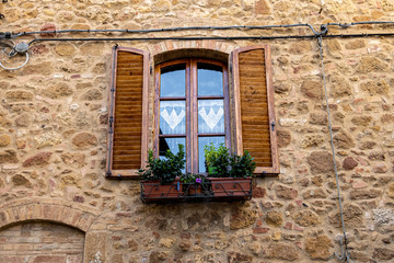 Fototapeta na wymiar romantic window with shutters in Tuscany, Italy