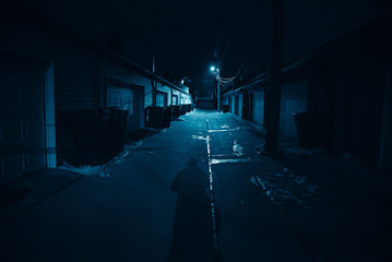 Dark and eerie urban city alley at night 