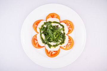 Mozzarella cheese with tomatoes, greens and sauce
