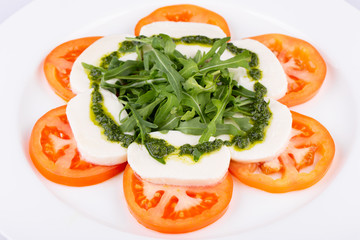 Mozzarella cheese with tomatoes, greens and sauce