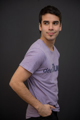 Handsome white young male model with short hair, and purple t-shirt 