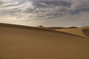 summer desert landscape on a warm sunny day from Maspalomas dunes on the Spanish island of Gran Canaria