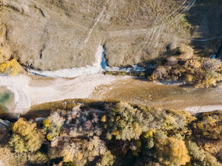 Top view in autumn on a mountain fast river in the forest