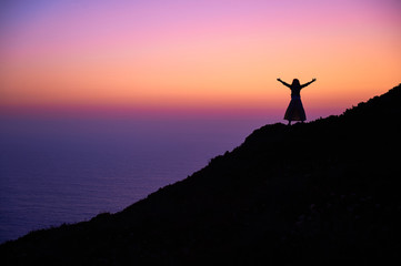 silhouette of girl with arms outstretched wide apart