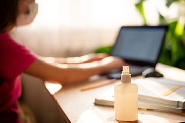 Schoolgirl working at a laptop, studying, having video call, communicating with a teacher while covid-19 epidemic