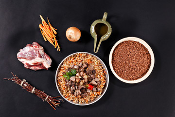 Ingredients of pilaf on black background.