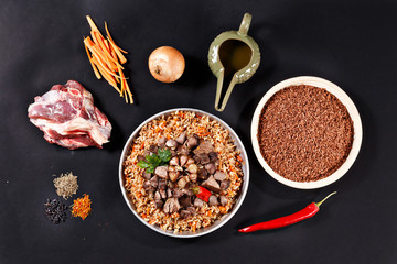 Ingredients of pilaf on black background.
