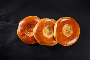 Uzbek bread. National middle asian buns. Black background.