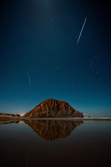 Shooting stars over Morro Rock at night