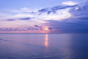 Beautiful blue sunset on the ocean with big waves and cliffs and cliffs. Bali island with its tropical and exotic nature. Sunrise over the sea and ocean. Phantom blue in sunset